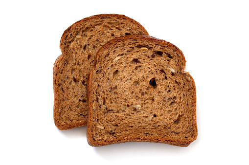 Two slices of wholewheat bread on white background