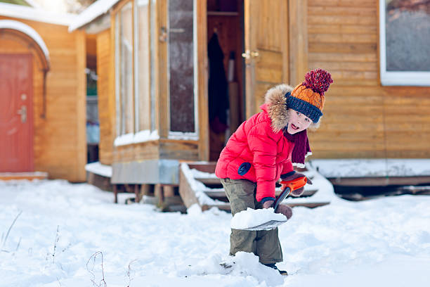 istock Child with shovel in winter 618433396