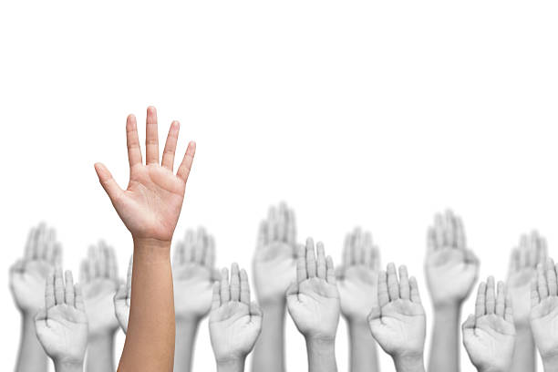 business crowd raising hands, many hands raise high up stock photo