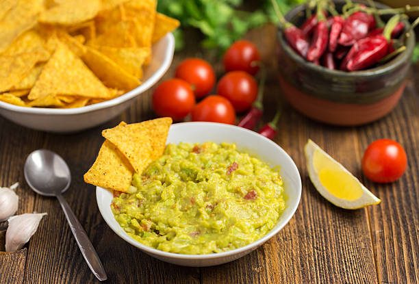 istock Guacamole in home white on wooden desk. 618434136