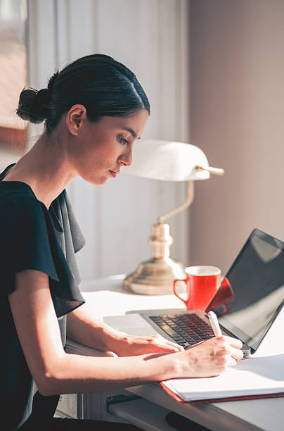 istock girl working at desk 618436520