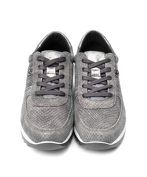 istock Gray female suede sneakers isolated on white background 618437298