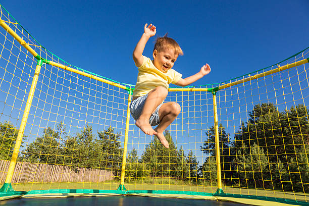 Little boy on a trampoline stock photo