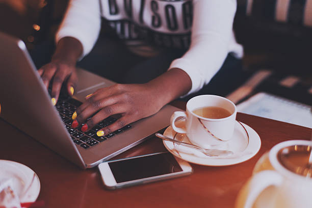 istock Black hands with  varicoloured nails on laptop keyboard in 618439902