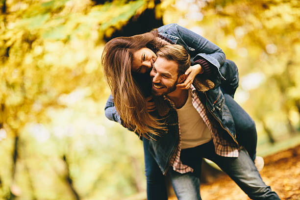 istock Young couple in the autumn park 618441382