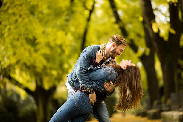 istock Young couple in the autumn park 618441408