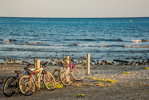 istock Seascape with bikes parked on the beach. 618441472