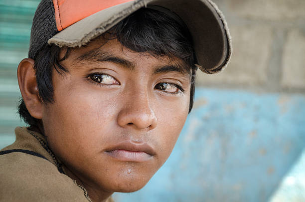 Latin American teen Great glance portrait from a young boy in the southern border of Mexico immigrant stock pictures, royalty-free photos & images