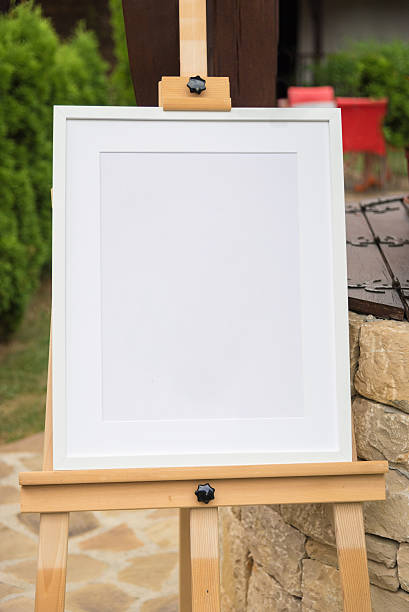 istock White frame mockup on a wooden stand 618442838