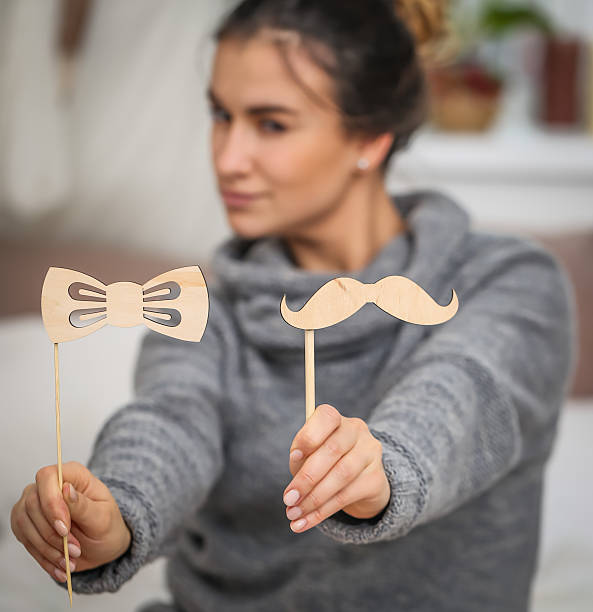 istock Beautiful young girl with a mustache 618444840