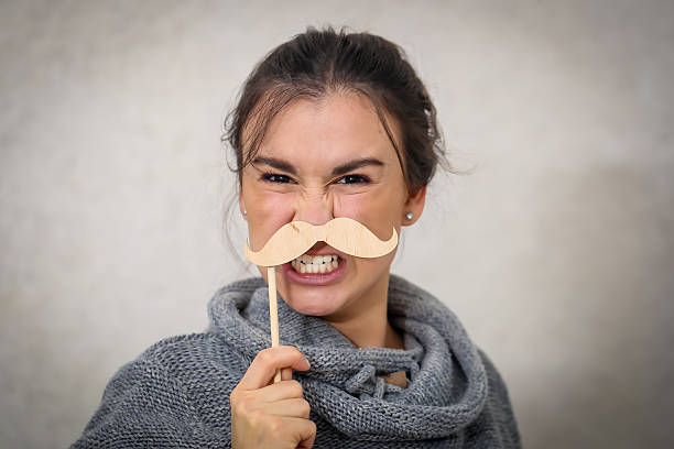 istock Beautiful young girl with a mustache 618444870