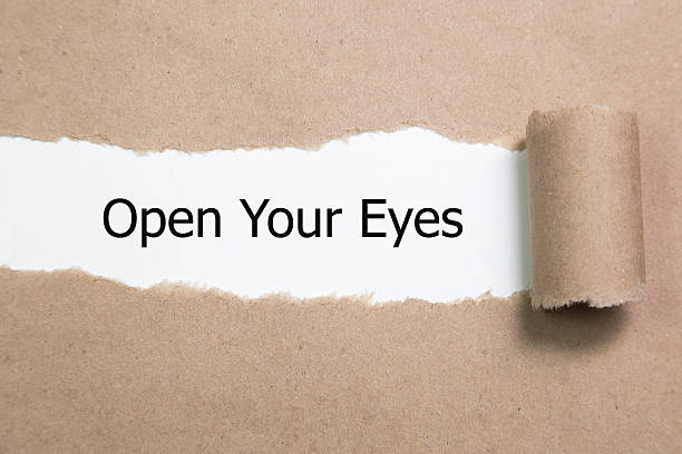 istock The text Open Your Eyes appearing behind torn paper. 618445138