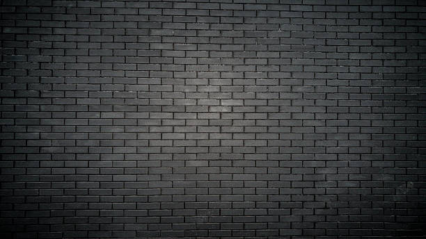 istock Toned shot of black brick wall on old building 618445392