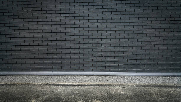 istock Horizontal photo of concrete floor and black brick wall 618446034