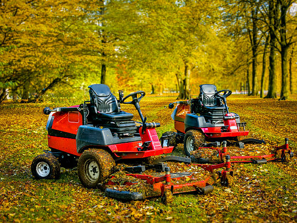 istock Lawn mowers in autumn park,two of them 618446248