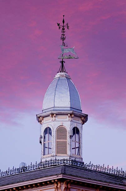 Old Courthouse at Dusk The cupola and weathervane on top of the Old Courthouse in Buena Vista, Colorado stand in silhouette against a brilliant pink and purple sunset, or known is called in the mountains as "alpenglo." wrought iron colorado courthouse victorian style stock pictures, royalty-free photos & images