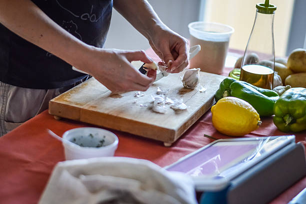 Peeling Garlic - preparing food with tablet