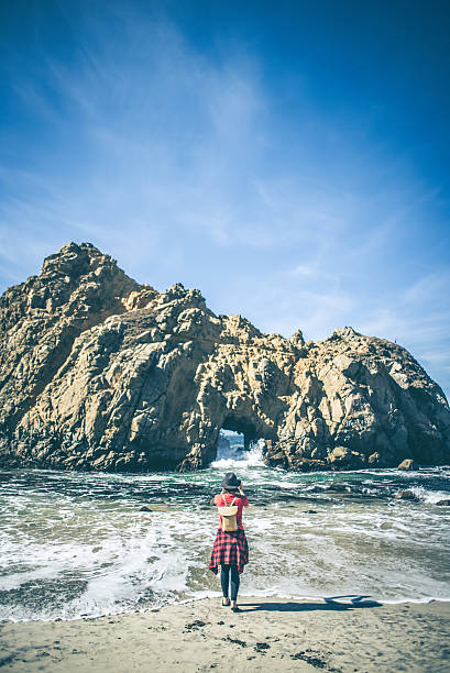 istock Young hipster taking a picture at the beach 618450288