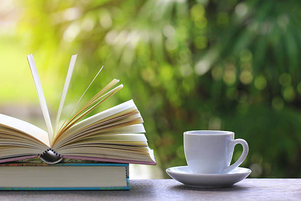 istock Cup of coffee with books on the table. 618454538