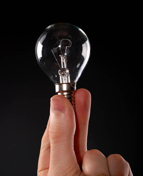 istock electric lamp in male fingers 618454636