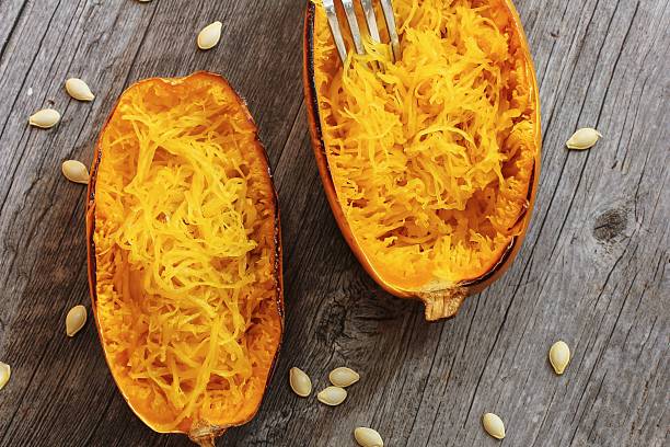 Spaghetti Squash top down view Spaghetti squash with bacon and spring onion topping top down view Spaghetti Squash stock pictures, royalty-free photos & images