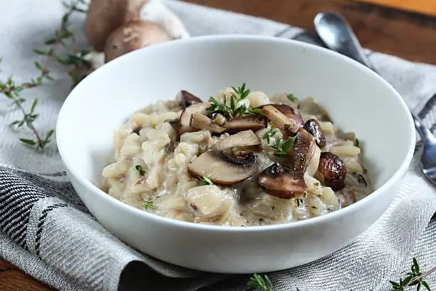 Bowl of Mushroom Risotto garnished with Thyme leaves, selective focus