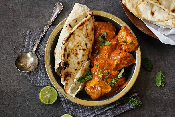 Butter Chicken served with homemade Indian Naan bread Butter chicken served with Homemade Indian Naan Bread / Murgh Makhani food styling stock pictures, royalty-free photos & images
