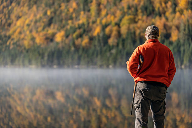 istock Senior Man Hunter Relaxing in Nature 618457128