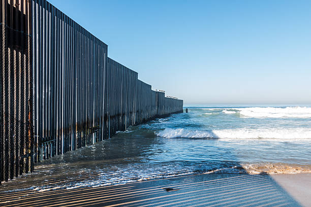 Border Field State Park Beach with International Border Wall stock photo