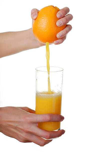 istock hands and glass of juice 618458968