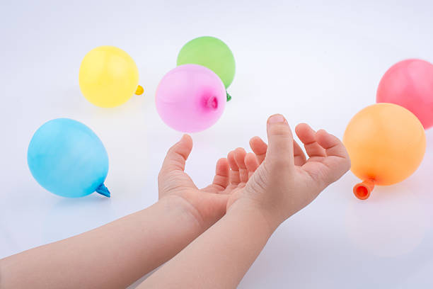 istock Hand holding Colorful Balloons 618459120