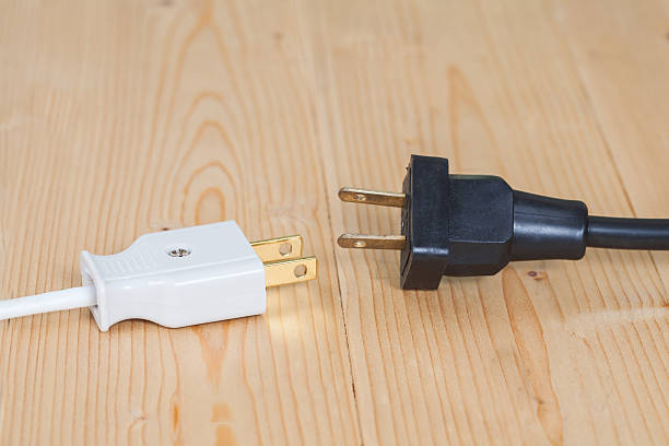 istock electric plug on wooden 618463460