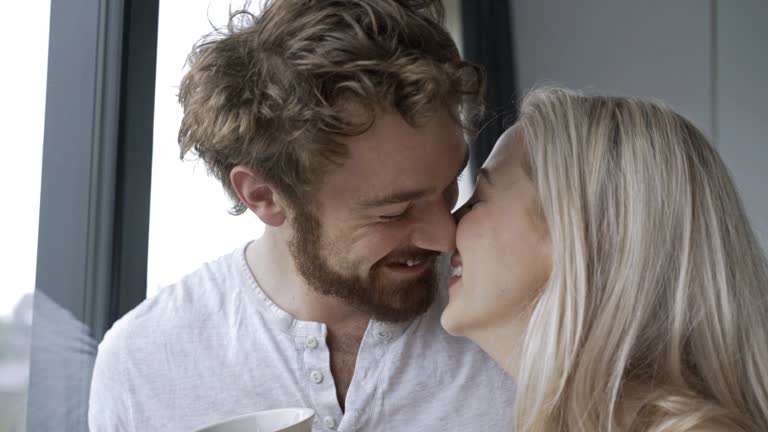 Close up on loving couple talking and kissing