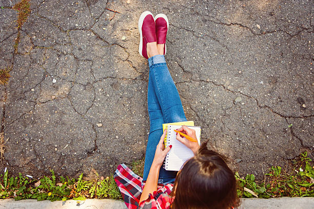 student studying outdoors stock photo