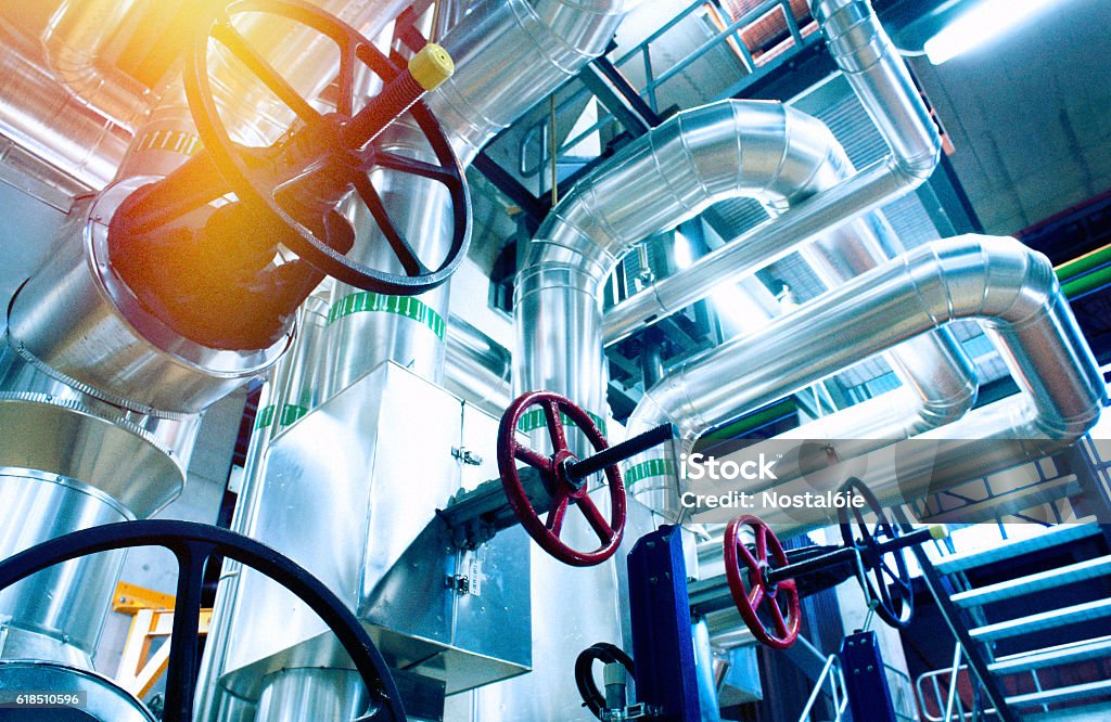 Industrial zone, Steel pipelines, valves and cables Equipment, cables and piping as found inside of a modern industrial power plant Natural Gas Stock Photo