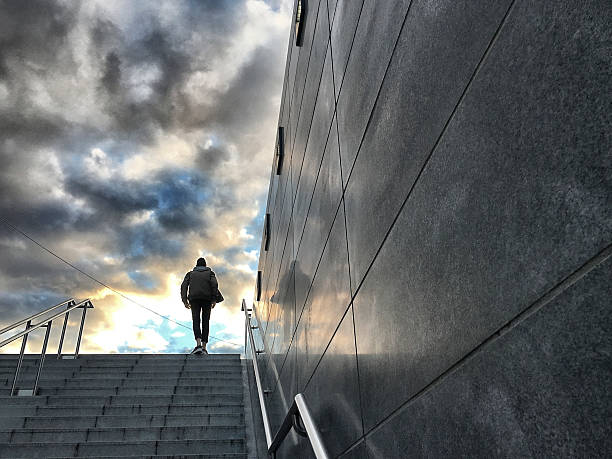 Walking up staircase stock photo