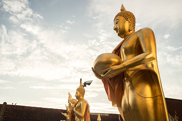 istock The golden standing Buddha image in Thai style. 618512386