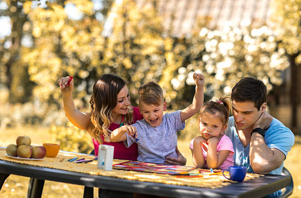 Young Parents And Children Playing Board Game In The Backyard Stock Photo - Download Image Now - iStock