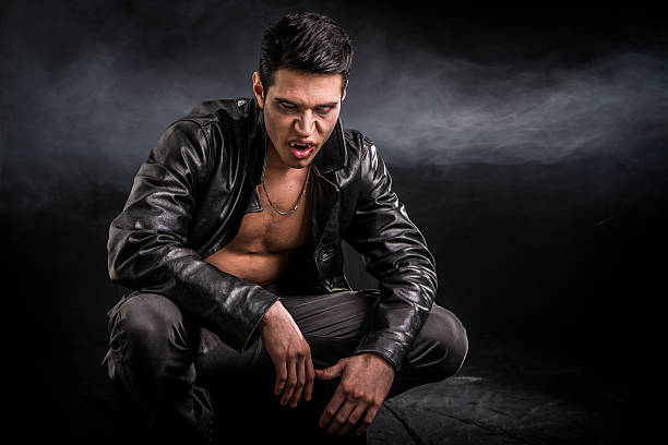 istock Young Vampire Man in an Open Black Leather Jacket 618512998
