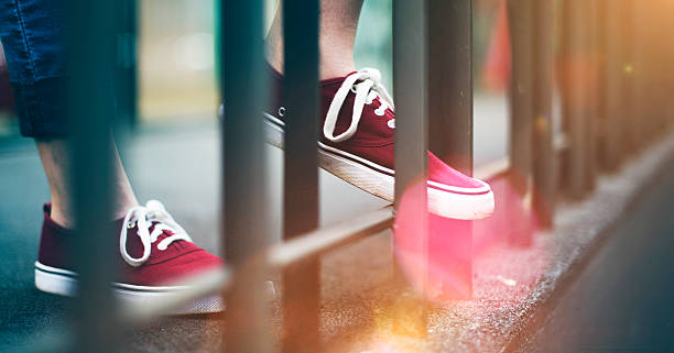 istock Sneakers Canvas Shoes Human Feet Legs Standing Concept 618517196