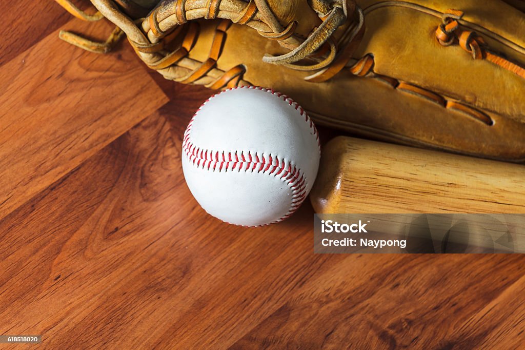 Baseball Baseball bat with ball and baseball glove on wood background Activity Stock Photo