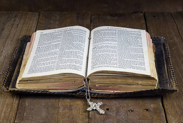 istock Old Holy Bible on rustic wood table 618518356