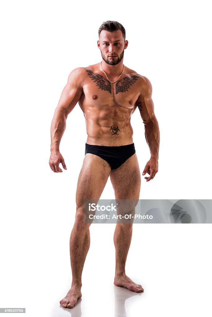 Handsome topless muscular man standing, isolated Handsome shirtless muscular man, standing, isolated on white background in studio shot Men Stock Photo