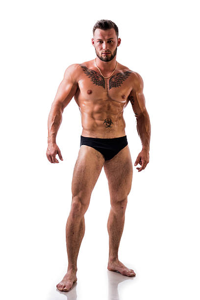 красивый топлес мышечной человек, стоя, изолированные  - body building exercising one man only tattoo стоковые фото и изображения