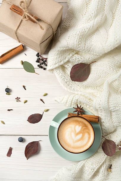 istock Autumn cappuccino coffee cup on white wood background 618520744