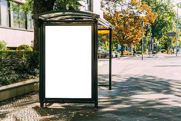 bus stop with billboard - bushalte stockfoto's en -beelden