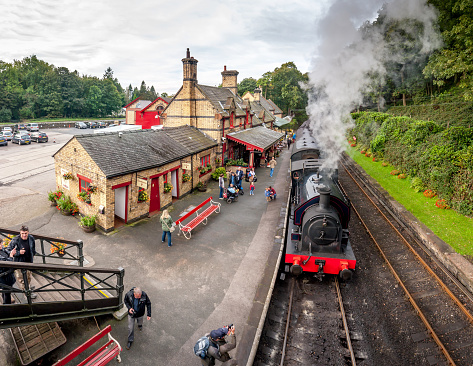 Haverthwaite, England - October 4, 2016: Tourists waiting at Haverthwaite Station, part of Lakeside and Haverthwaite Railway. A 3 image panorama.
