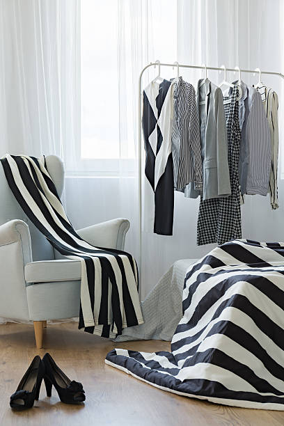 istock Woman room with clothes rack 618522426