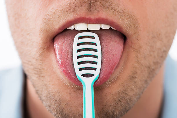 istock Man Cleaning Her Tongue 618523192