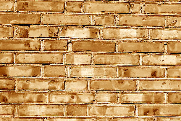 istock Grungy orange toned brick house wall. 618523260